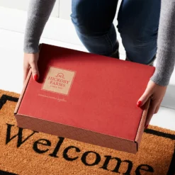 Deluxe Signature Charcuterie Gift Box -HICKORY FARMS Sales mailer box doorstep hands alt